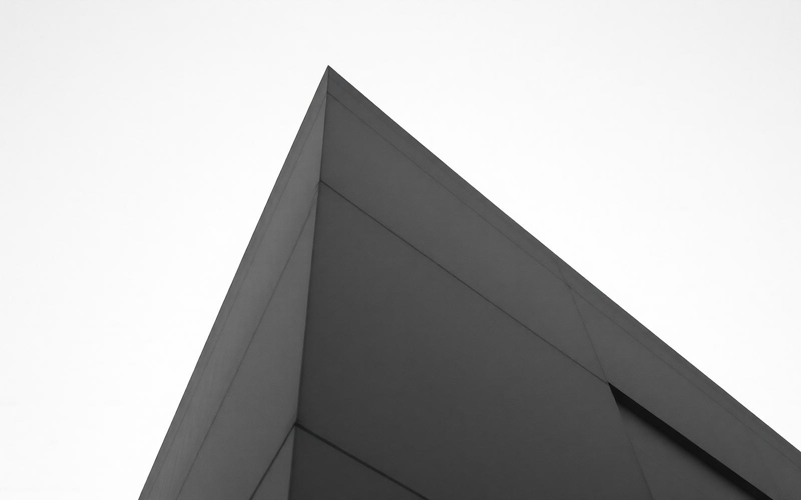 Black and white modernist building corner against sky