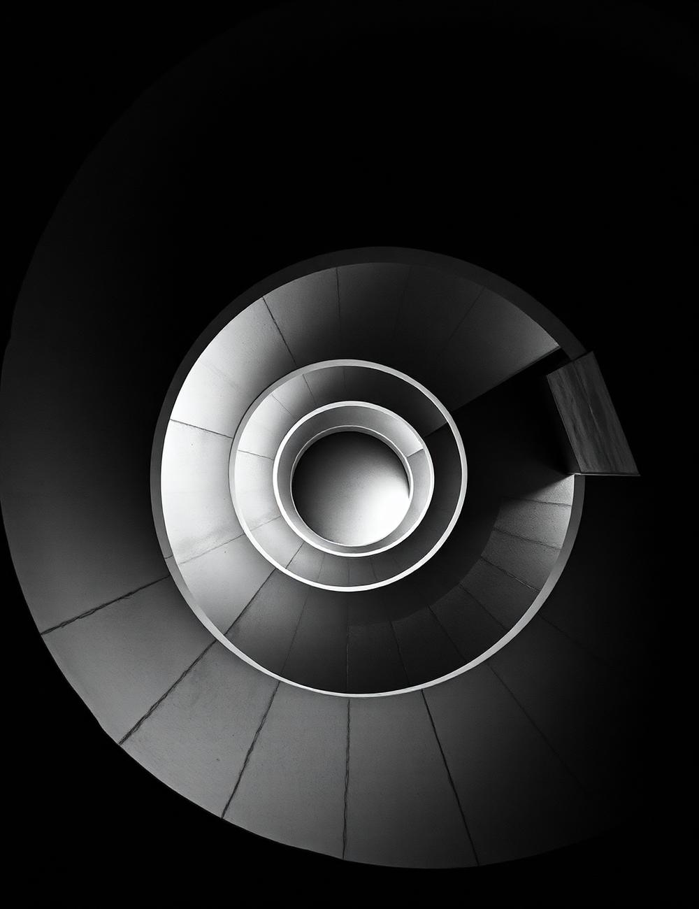 Black and white spiral staircase seen from below